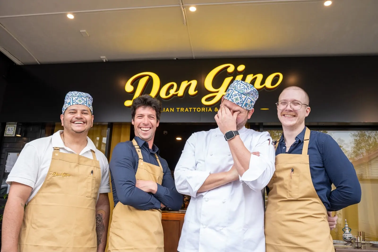 The Don Gino team outside the venue, under the sign