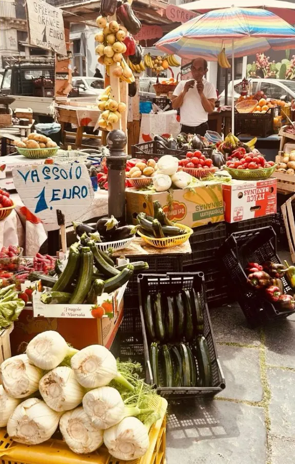 A street market in Sicily, fennel and zucchini at the front